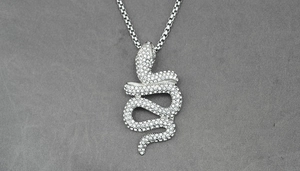 Macro view of silver rattlesnake pendant with shimmering white cubic zirconia stones