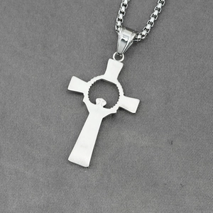 Silver hollow cross pendant necklace with box chain on dark textured background