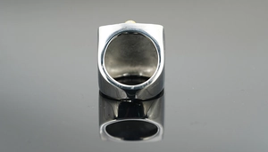 Polished stainless steel men's signet ring with solid industrial finish and reflection