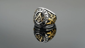 Detailed macro view of the silver and gold Masonic signet ring with engraved compass and G
