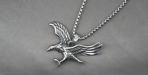 Macro shot of stainless steel eagle pendant with detailed wings and pearl chain link