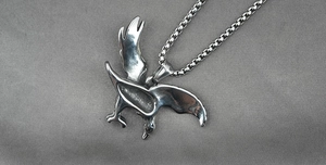 Macro detail of retro eagle pendant necklace featuring vintage steel feather textures