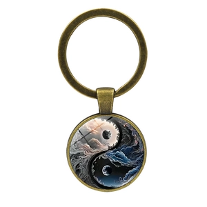 Vintage bronze keychain with celestial yin yang pattern and nebula glass dome pendant