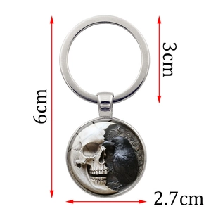 Gothic metal keychain with skull and black raven design, silver finish, 6cm total length