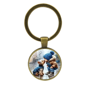 Porte-clés vintage en bronze avec pendentif rond illustrant un garçon et un chien