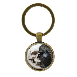 Gothic keychain with raven and skull art pendant in bronze finish metal ring