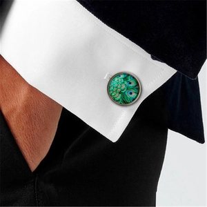 Men's vintage peacock feather glass cufflinks on a white dress shirt with black suit