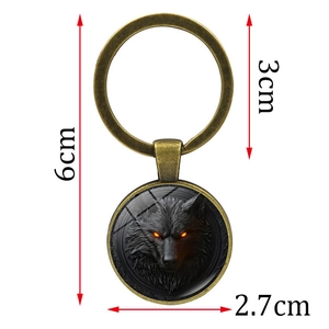 Vintage bronze wolf head keychain with orange glowing eyes and dimension markings