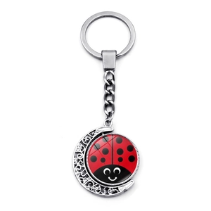 Creative silver crescent moon keychain with a cute cartoon red ladybug pattern charm