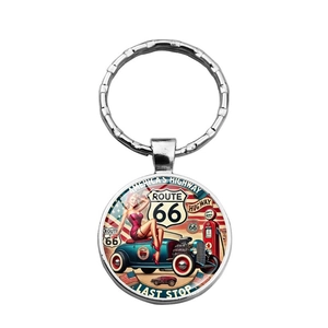 Macro detail of the vintage Route 66 keychain with retro car art and silver metal frame