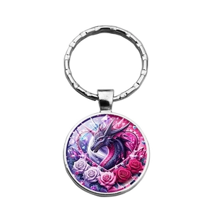 Classic fantasy dragon and rose metal keychain with glass dome pendant on white background