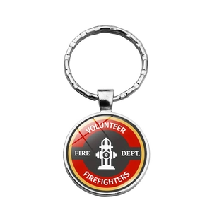 Detailed close-up of Volunteer Fire Dept metal keychain with round fire hydrant emblem