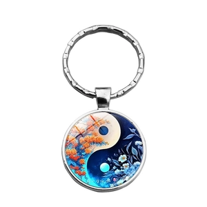 Close-up of Yin Yang Life Tree glass keychain with silver metal ring and autumn floral art
