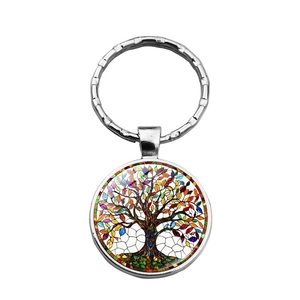 Macro shot of silver alloy tree of life keychain with colorful mosaic glass pendant