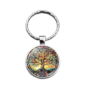 Detailed macro shot of a silver tree of life keychain with colorful stained glass art