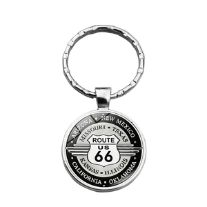 Close-up of metal Route 66 keychain with engraved names of the eight US states