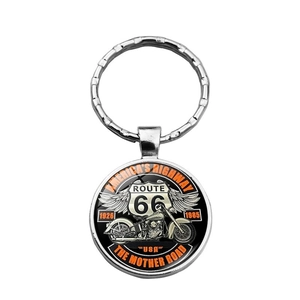 Detail of Route 66 glass pendant keychain featuring vintage motorcycle and wing design