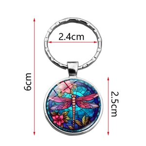 Silver metal dragonfly keychain with colorful flower pendant and circular glass charm