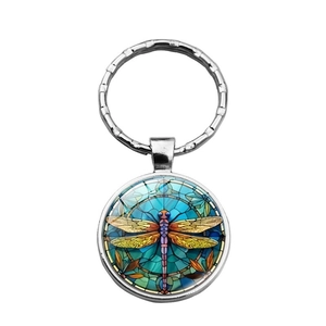 Artistic dragonfly keychain with silver metal ring and colorful glass pendant on white background