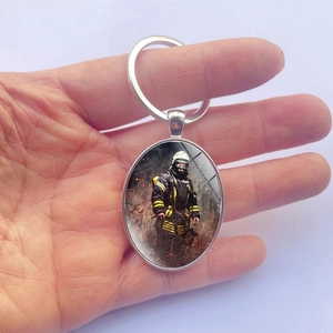 Silver oval keychain with firefighter emblem, premium metal ring for car bags and keys