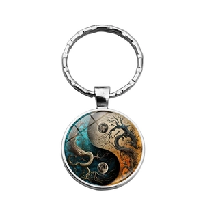 Yin Yang Tree of Life metal keychain with blue and orange artistic pendant on white background