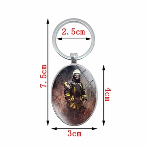 Oval metal keychain featuring realistic firefighter print on silver ring pendant