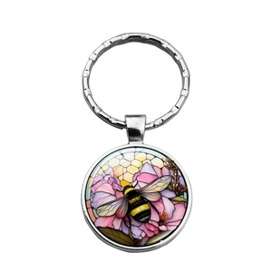 Creative metal keychain with bee and pink flower pattern in a yellow honeycomb design