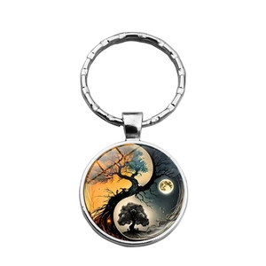 Detailed view of the Yin Yang Tree of Life metal keychain with artistic glass dome pendant