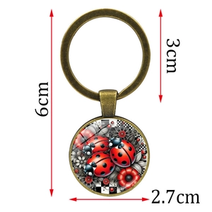 Detail showing the dimensions of the ladybug glass pendant and bronze metal keychain ring