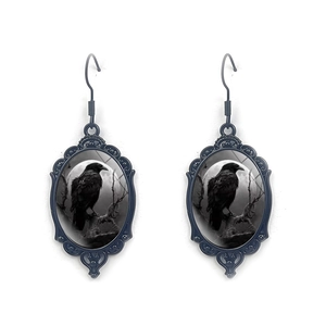 Detailed view of Gothic raven earrings featuring an oval frame and vintage black floral accents