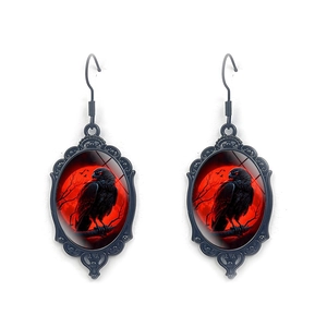 Gothic raven earrings with red moon pattern and intricate black metal hollow frame