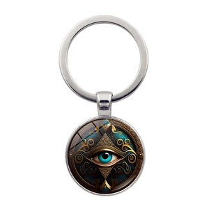 Macro shot of silver Hamsa Evil Eye keychain with blue eye design and glass dome