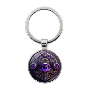 Macro shot of silver Hamsa Evil Eye keychain with purple mystical eye design on white background