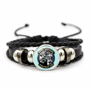 Detail of multi-layer leather bracelet featuring Saint Michael protector glass cabochon