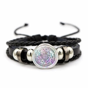 Macro view of multi-layer black leather bracelet with Archangels seal glass charm
