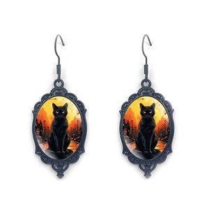 Detail of gothic black cat earrings with vintage oval glass pendants for Halloween