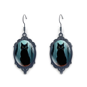 Macro detail of gothic black cat oval earrings with vintage lace metal frame design
