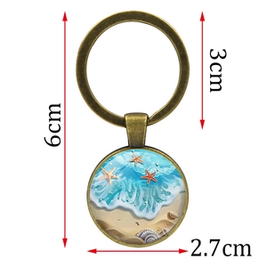 Porte-clés mer et étoile de mer en métal avec pendentif en verre, longueur totale 6 cm