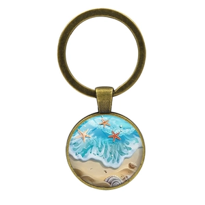 Porte-clés étoile de mer plage océan avec anneau en bronze et pendentif coquillage