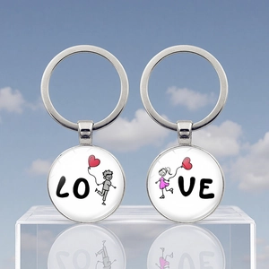 Detailed close-up of metal couple keychains featuring LOVE cartoon character designs