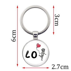 Metal keychain with cartoon boy holding heart balloon and LO letter print on round pendant