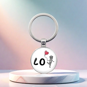 Macro detail of silver metal keychain featuring a cute boy with a red heart balloon