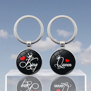 Close-up of King and Queen couple keychains showing metal pendants with crown heart designs