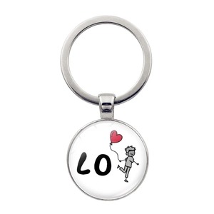 Detailed view of round metal keychain with cartoon boy holding red heart balloon and LO text