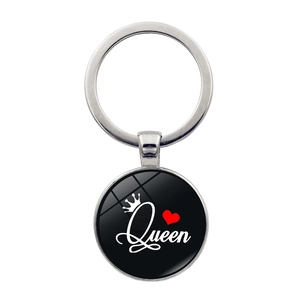 Detailed close-up of Queen themed keychain with silver alloy ring and black glass pendant