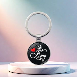 Macro detail of King keychain with silver alloy ring and glass dome on marble