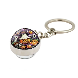 Detail of Halloween keychain with glass dome pumpkin and ghost illustrations