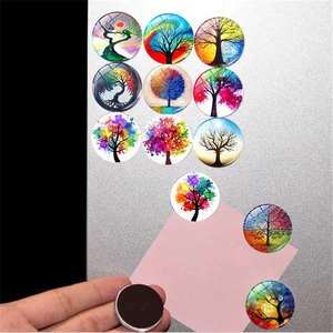 Close-up of tree of life glass magnets showing magnetic backing and artistic patterns