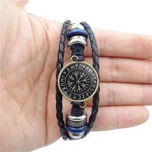 Detailed close-up of a Viking Vegvisir compass leather bracelet with Nordic rune charms