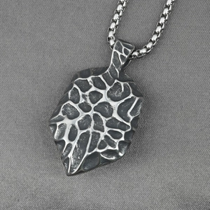 Titanium steel Evil Eye necklace with vintage cracked texture pendant on gray fabric
